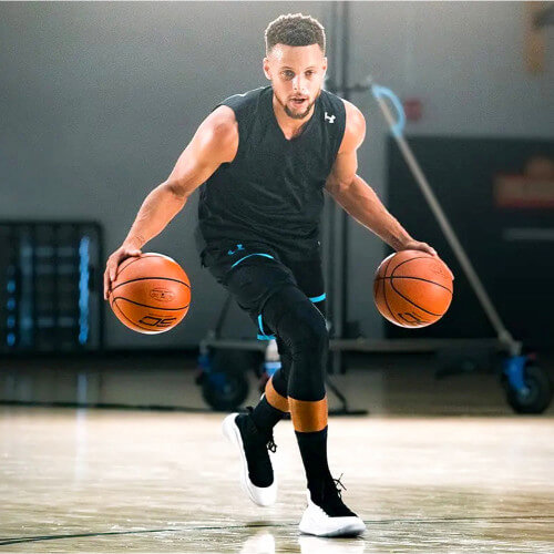 Stephen Curry dribbling with 2 basketballs - Gifts for 14 Year Old Boys