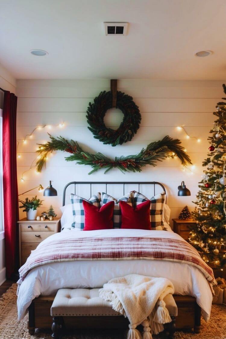 A cozy farmhouse bedroom with a rustic Christmas wreath hanging above the bed, surrounded by warm and inviting holiday decor