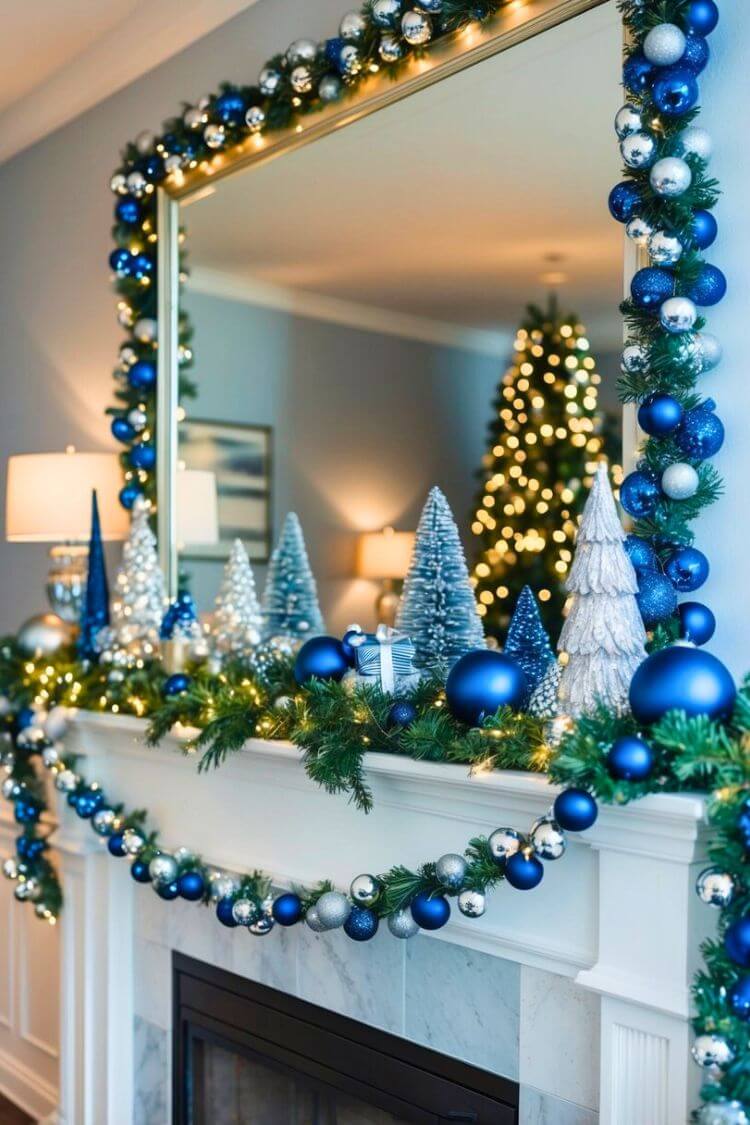 A mantle adorned with blue and silver Christmas decorations, including ornaments, garland, and twinkling lights